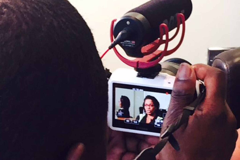 Home 42 Movie director being interviewed on camera.