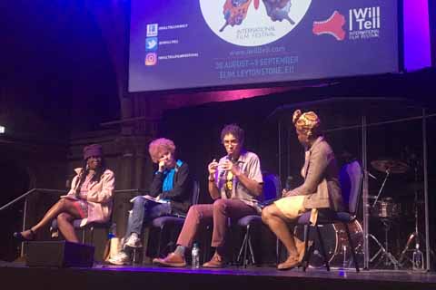 Home 17 Jenny Lee interviewing movie directors on stage at the I Will Tell film festival with audience discussion.