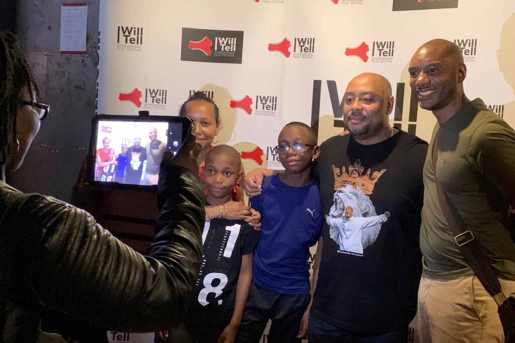 Home 29 Raymond Santana with a I Will Tell international film festival audience members having their photo taken on the red carpet.