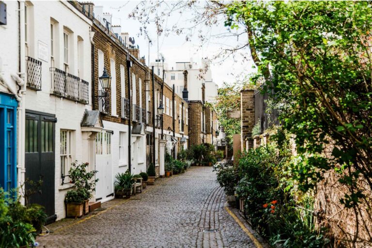 London street scene with mews houses along a cobbled road.